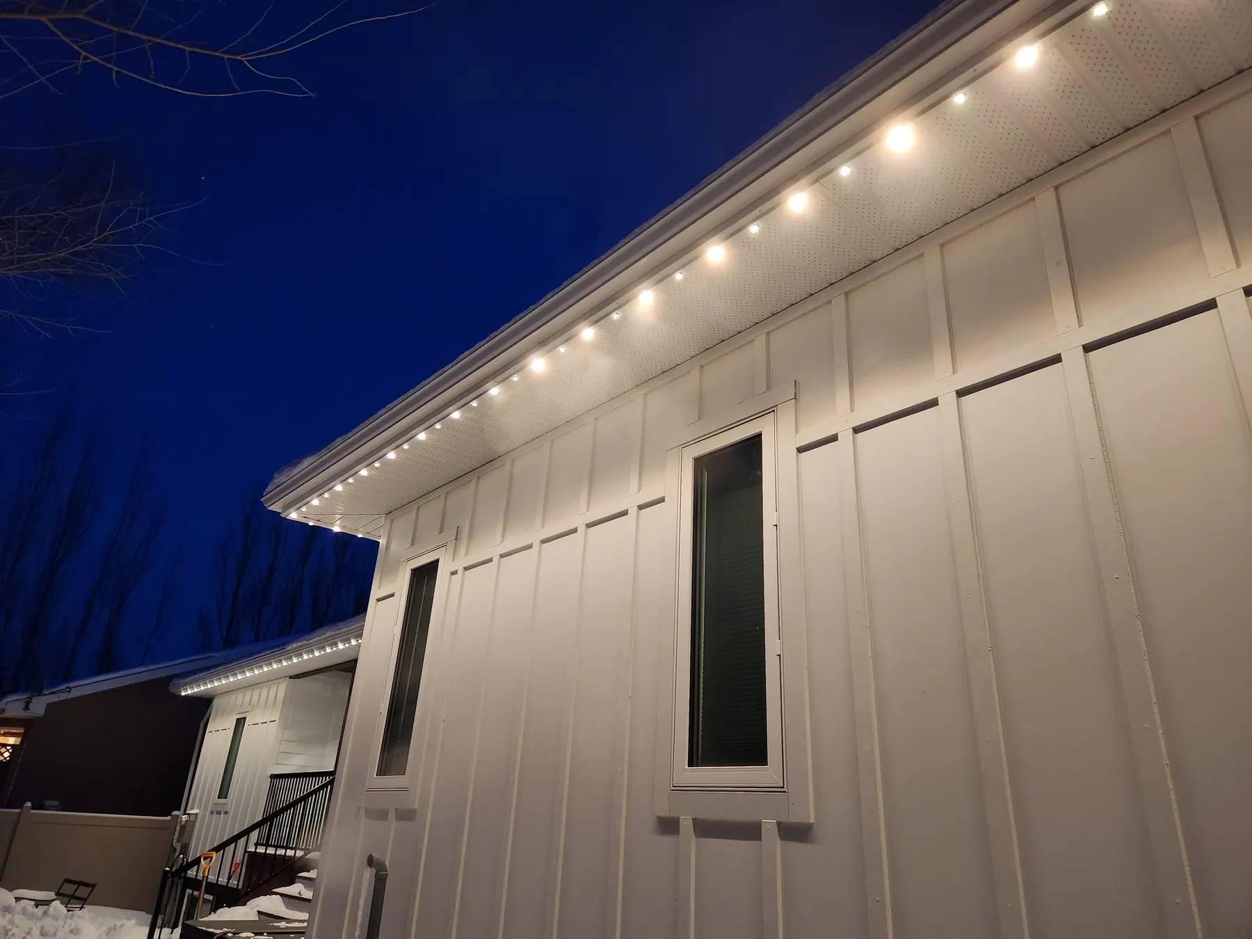 Close-up of warm white LED pucks in an aluminum soffit track