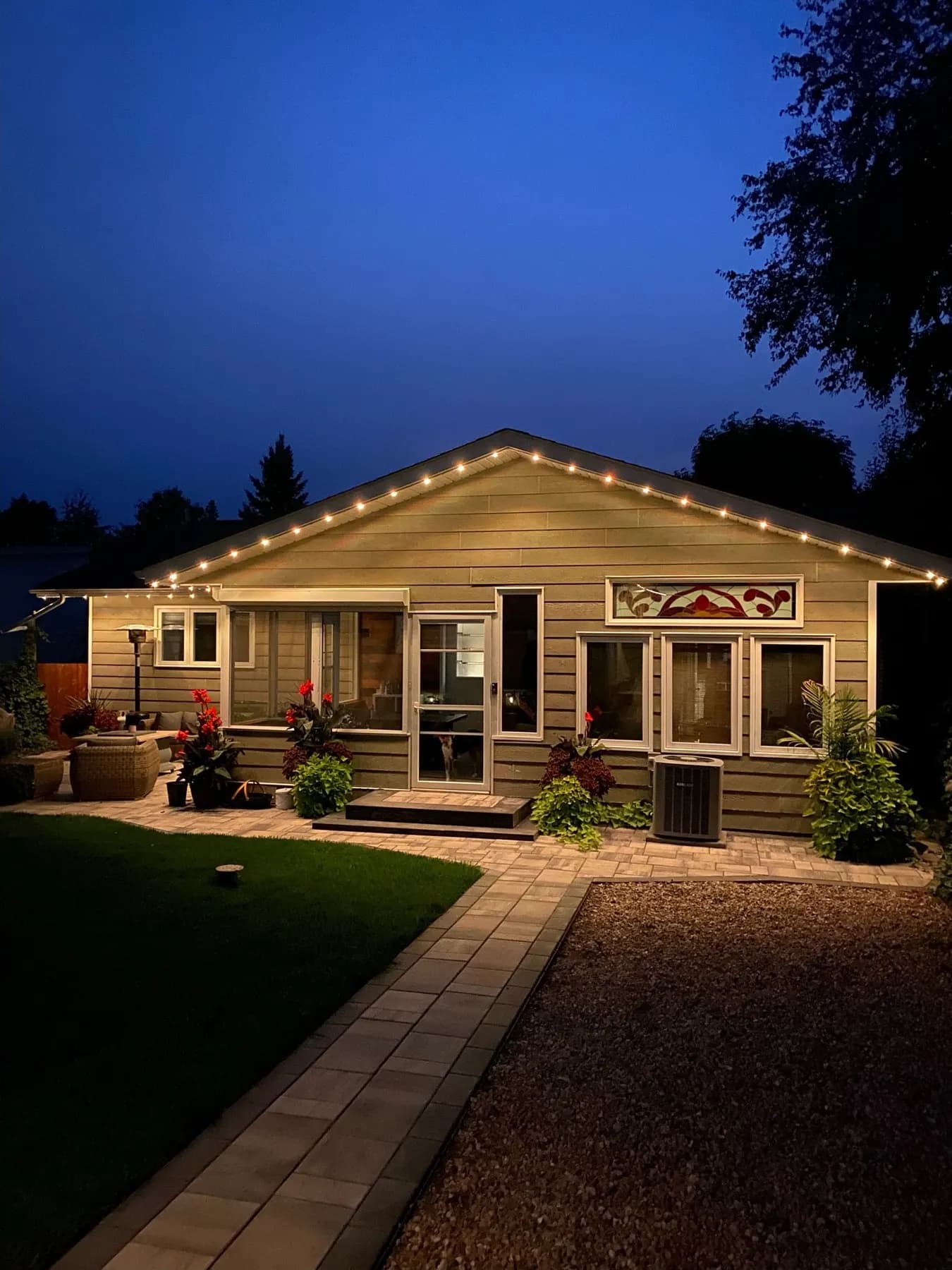 Warm white permanent lights on a cottage porch in the evening