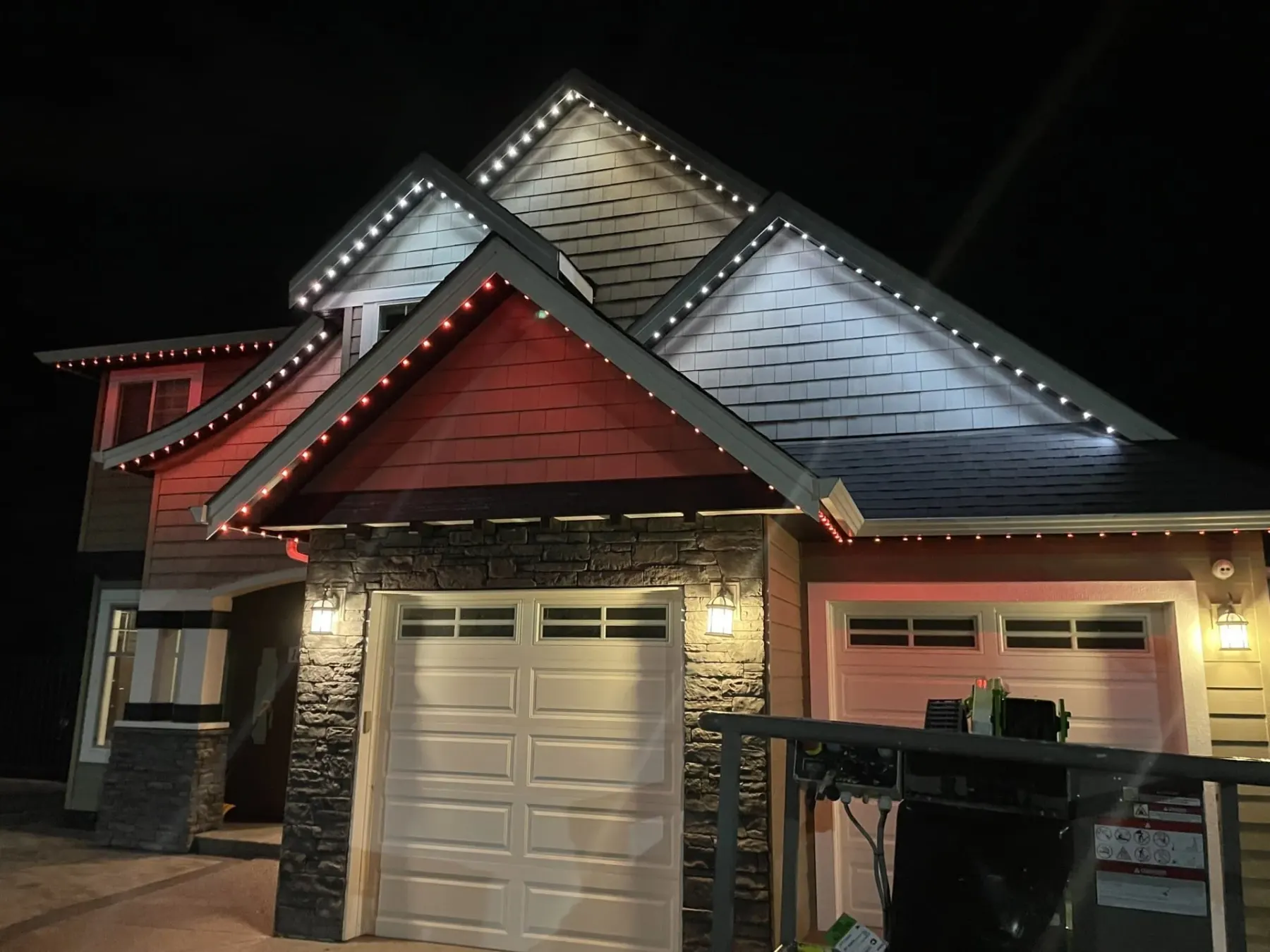 Permanent LED pucks along a garage soffit at dusk