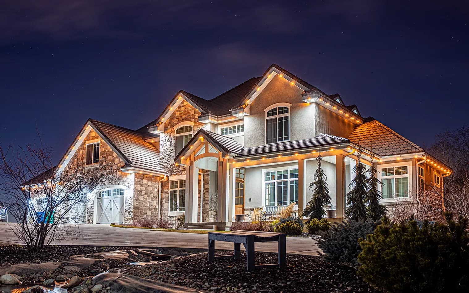 White permanent lighting used as security lighting on a large home